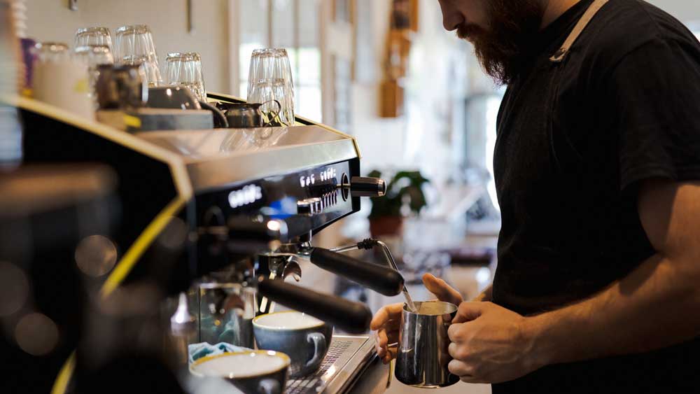 barista on coffee machine