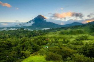 Costa Rica Specialty Coffee. Fields of green with volcano in background.